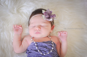 newborn with purple flower