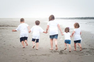 cousins running on beach