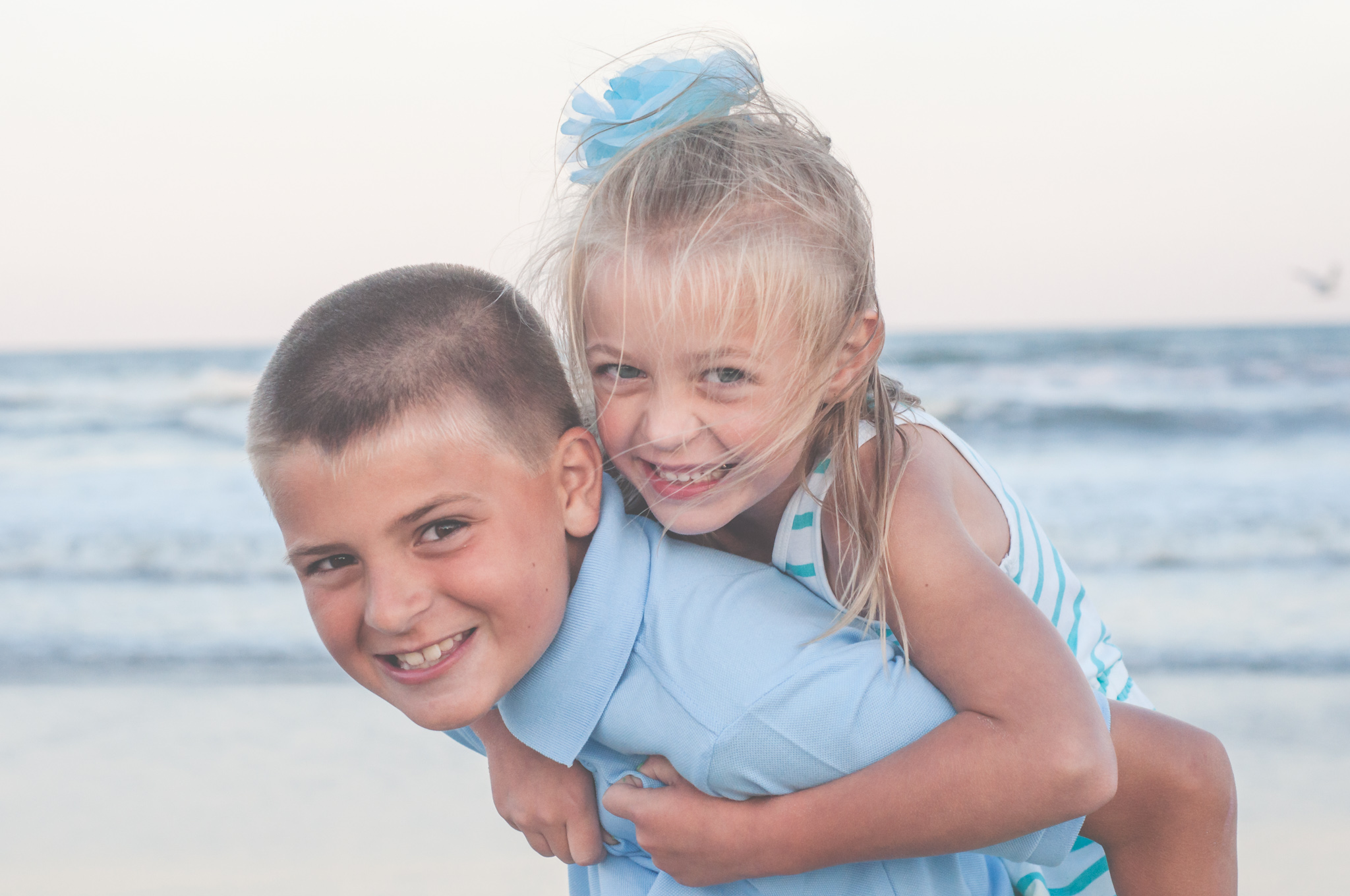 brother gives sister piggie back ride jersey shore photos