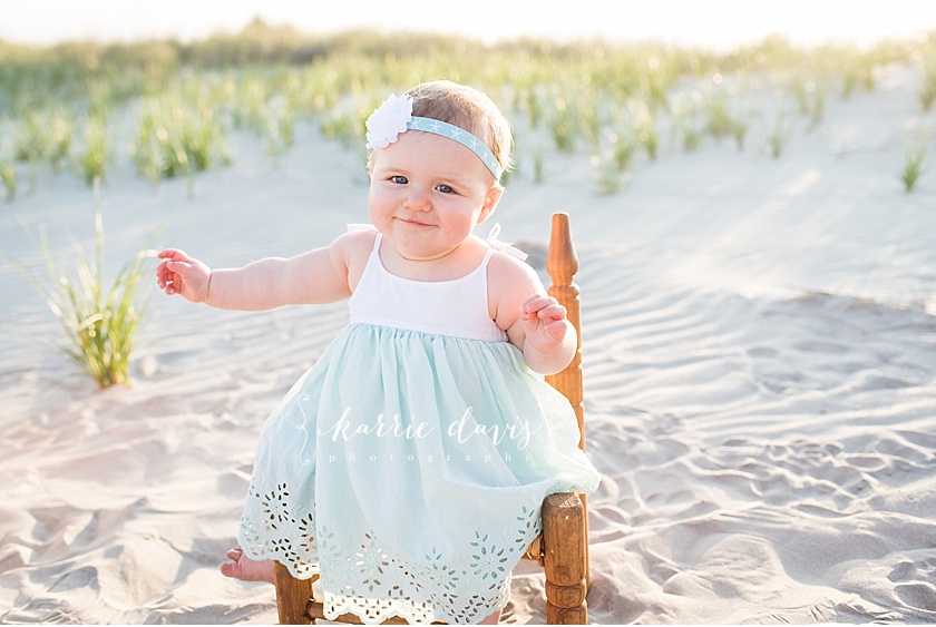 Photo of cute baby sitting on chair at a beach in New Jersey for family pictures