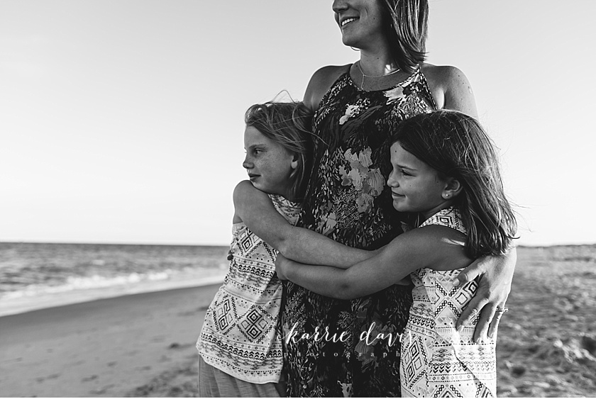 nj family photographer captured this stunning portrait of mom and two daughters at the beach