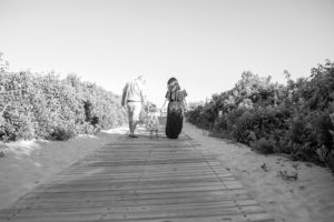 family strolling on beach walkway